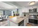 Modern kitchen with stainless steel appliances, granite counters, and ample cabinet space open to the dining area at 4311 2Nd E Ave, Bradenton, FL 34208