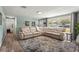 Inviting living room with a comfortable sectional sofa, a large window, and wood-look flooring at 4311 2Nd E Ave, Bradenton, FL 34208