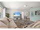 Comfortable living room featuring a large sectional sofa, modern entertainment center, and stylish area rug at 4311 2Nd E Ave, Bradenton, FL 34208