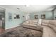 Inviting living room with a plush sectional sofa, stylish rug, and soothing paint color create a cozy atmosphere at 4311 2Nd E Ave, Bradenton, FL 34208