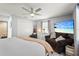 The main bedroom features a ceiling fan, TV, closet, and large windows at 4311 2Nd E Ave, Bradenton, FL 34208