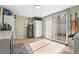 The utility room features tile floors, a closet, a refrigerator, and a sliding glass door at 4311 2Nd E Ave, Bradenton, FL 34208