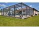 A screened pool overlooks the lawn and is surrounded by the screen enclosure at 4406 Baltry Ct, Bradenton, FL 34211