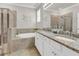 Beautiful bathroom with dual sinks, granite countertops, soaking tub, and glass-enclosed shower at 4406 Baltry Ct, Bradenton, FL 34211