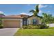 Beautiful one-story home with well-manicured lawn, paver driveway and tile roof, and lush landscaping at 4406 Baltry Ct, Bradenton, FL 34211