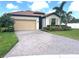 Charming one-story home with paver driveway, two car garage, well-kept lawn, and colorful landscaping at 4406 Baltry Ct, Bradenton, FL 34211