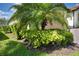 A neatly landscaped yard with a palm tree accents the exterior of this home at 4406 Baltry Ct, Bradenton, FL 34211