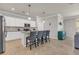 This kitchen features an island with seating, stainless steel appliances, and white cabinets at 4406 Baltry Ct, Bradenton, FL 34211