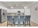 This kitchen features an island with seating, stainless steel appliances, and white cabinets at 4406 Baltry Ct, Bradenton, FL 34211