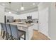 This kitchen features an island with seating, stainless steel appliances, and white cabinets at 4406 Baltry Ct, Bradenton, FL 34211