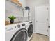 This laundry room features modern appliances, storage and tile floors at 4406 Baltry Ct, Bradenton, FL 34211
