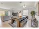 Open-concept living room with a pool table and access to the patio at 4406 Baltry Ct, Bradenton, FL 34211