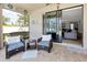 Covered outdoor patio with comfortable seating and sliding door to the house at 4406 Baltry Ct, Bradenton, FL 34211