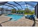 A screened pool features a spa and plenty of seating around the pool deck at 4406 Baltry Ct, Bradenton, FL 34211