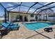A screened pool features a connected spa and a patio with outdoor seating at 4406 Baltry Ct, Bradenton, FL 34211