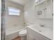 Bright bathroom features a shower-tub combo, vanity, and a medicine cabinet at 441 Venetia Ave, North Port, FL 34287