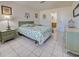 Bright bedroom featuring a bed with a green and white patterned comforter and matching bedside tables at 441 Venetia Ave, North Port, FL 34287