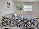 Comfortable bedroom showcasing a well-made bed and natural light from the window at 441 Venetia Ave, North Port, FL 34287