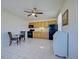 Efficient kitchen boasts wood cabinets, black appliances, and a ceiling fan at 441 Venetia Ave, North Port, FL 34287