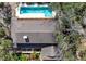 An aerial view of the home featuring a backyard swimming pool, lush landscaping and a shaded deck at 4711 Ocean Blvd, Sarasota, FL 34242