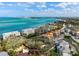 Aerial view of the property featuring a swimming pool and lush landscaping, close to the beach at 4711 Ocean Blvd, Sarasota, FL 34242