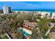 Overhead view of home with landscaping, mature trees and nearby white sandy beaches at 4711 Ocean Blvd, Sarasota, FL 34242