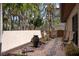 Zen backyard featuring stone pathway, small water feature, lush landscaping, and lounging chairs at 4711 Ocean Blvd, Sarasota, FL 34242