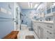 Bright bathroom with dual sinks, white cabinets, and modern fixtures at 4711 Ocean Blvd, Sarasota, FL 34242