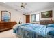 Cozy bedroom with natural light, a large mirror and dresser, and simple decor at 4711 Ocean Blvd, Sarasota, FL 34242