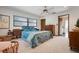 Bright bedroom with blue bedding, a window for natural light, and a view to the bathroom at 4711 Ocean Blvd, Sarasota, FL 34242
