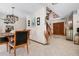 Dining area adjacent to the foyer, with a view of double entry doors and open staircase at 4711 Ocean Blvd, Sarasota, FL 34242