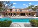 Gorgeous two-story home with a pool, balconies, and outdoor kitchen at 4711 Ocean Blvd, Sarasota, FL 34242