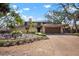 Inviting home featuring a meticulously landscaped front yard and a two-car garage at 4711 Ocean Blvd, Sarasota, FL 34242