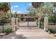 Gated property entrance showcasing driveway with landscaped greenery and home in the background at 4711 Ocean Blvd, Sarasota, FL 34242