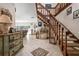 Grand foyer with decorative tile inlay, staircase and unique furnishings at 4711 Ocean Blvd, Sarasota, FL 34242