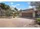 Beautiful home with mature trees, tropical landscaping, and spacious driveway at 4711 Ocean Blvd, Sarasota, FL 34242