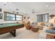 Relaxing game room featuring a pool table, sectional sofa, and bright natural light at 4711 Ocean Blvd, Sarasota, FL 34242