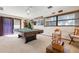 Spacious game room includes a pool table, sliding glass doors, and large windows at 4711 Ocean Blvd, Sarasota, FL 34242
