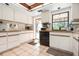 Cozy kitchen featuring white cabinets and a view to the backyard and pool area at 4711 Ocean Blvd, Sarasota, FL 34242