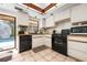 Well-lit kitchen featuring white cabinetry and modern black appliances at 4711 Ocean Blvd, Sarasota, FL 34242
