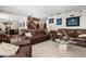 Spacious living room with multiple sofas, an open staircase, and tile flooring at 4711 Ocean Blvd, Sarasota, FL 34242