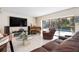 Spacious living room with a piano, comfortable seating, and pool view at 4711 Ocean Blvd, Sarasota, FL 34242