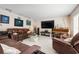 Comfortable living room with piano, entertainment center, and large sectional sofa at 4711 Ocean Blvd, Sarasota, FL 34242