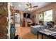 View of the living room featuring a stone fireplace, desk and the sliding door to the patio at 4711 Ocean Blvd, Sarasota, FL 34242