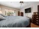 Spacious main bedroom featuring a large bed and a wall mounted television at 4711 Ocean Blvd, Sarasota, FL 34242