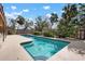 An inviting pool features a unique shape and plenty of patio space for lounging at 4711 Ocean Blvd, Sarasota, FL 34242