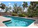 A stunning backyard pool area is nestled amongst lush trees and landscaping at 4711 Ocean Blvd, Sarasota, FL 34242