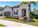 Charming home featuring a two-car garage, stone accents, manicured landscaping, and a tiled roof at 4889 Antrim Dr, Sarasota, FL 34240