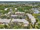 Bird's eye view of a residential area with lush landscaping and a lake view in the background at 510 Spring Lakes Blvd, Bradenton, FL 34210