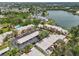 Aerial view of a residential community offering swimming pools and lake views in a mature landscape at 510 Spring Lakes Blvd, Bradenton, FL 34210